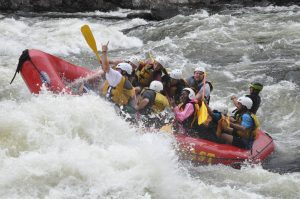 People On a Boat Going Through Rapids