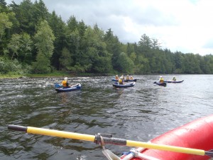 Group of People Kayaking on a River