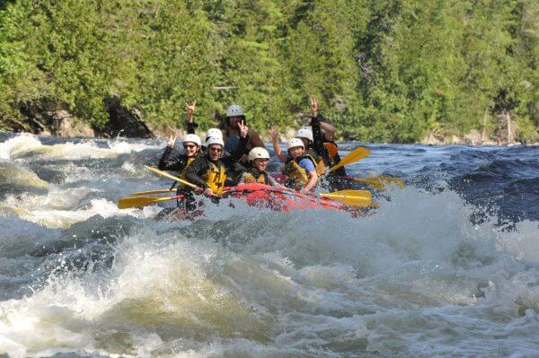 People on a boat in a whitewater river