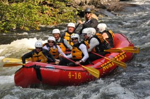 Group of People Whitewater Rafting
