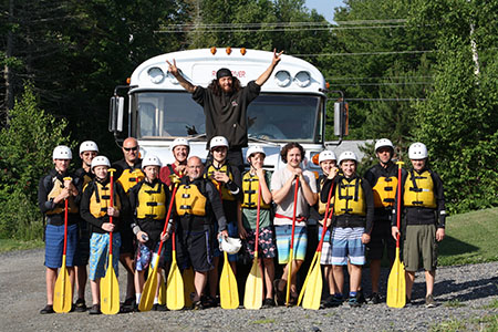 Group of Scouts With Their Rafting Gear On in Front of a Bus