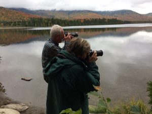 Man and a Woman Taking a Picture of a Lake